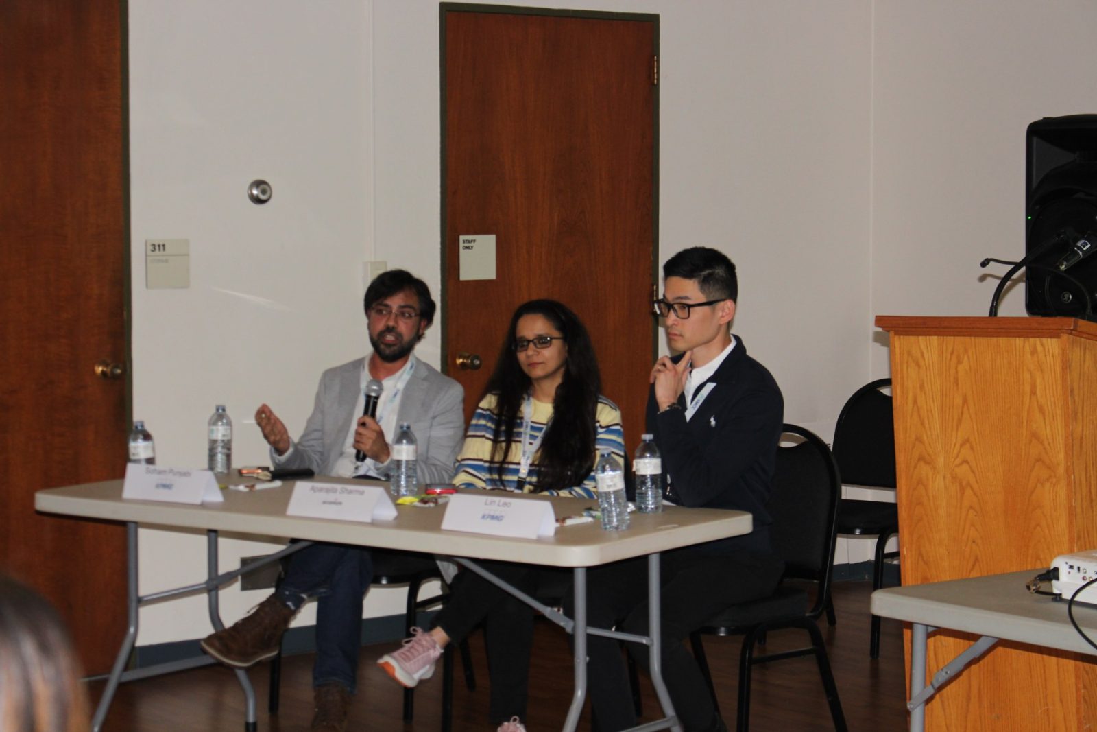 An SMCC panel seated at a table, taking questions from the room.